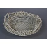 A BELLEEK PORCELAIN FLORALLY ENCRUSTED BASKET, bell flower rim with wicker work style border, bark