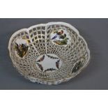 A LATE 19TH CENTURY BERLIN PORCELAIN PIERCED BOWL, the exterior with vignettes of floral sprays