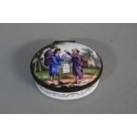 A LATE 18TH CENTURY PORCELAIN AND ENAMEL OVAL PATCH BOX, the cover painted with a traveller and a