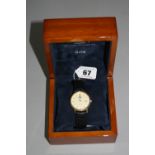 A 9CT ROTARY ELITE DATE WATCH, on leather strap, box and papers