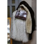 A WHITE FUR JACKET, TWO FUR STOLES AND A HANDBAG