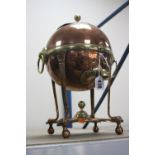 AN ADAM STYLE COPPER AND BRASS SAMOVAR, of spherical form on slender tapering reeded legs, with ring