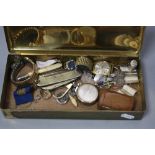 A TIN OF MISCELLANEOUS ITEMS, including watch, badges, penknives, etc