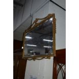 A GILT BEVELLED WALL MIRROR, approximate size 93cm x 58cm