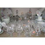 A COLLECTION OF GLASSWARE, including decanters, champagne flutes, vases, ice bucket, drinking