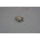 A MODERN 18CT GOLD DIAMOND TWO STONE RING, crossover design with twist rope decoration, estimated