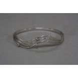 A 9CT WHITE GOLD DIAMOND BANGLE