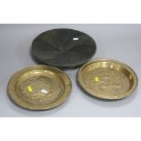 A PAIR OF BRASS PLAQUES, diameter approximately 25cm, together with a bronzed three footed bowl (3)