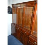 A MODERN MAHOGANY BOOKCASE, with three bevelled glass doors to the upper and three drawers and three