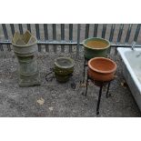 THREE GARDEN PLANTERS, on metal stands and a castlated chimney pot (4)