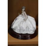 A LLADRO FIGURINE, 'At The Ball', depicting lady sitting in ball gown holding a fan, impressed