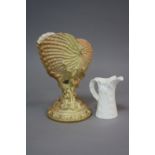 A ROYAL WORCESTER BLUSH IVORY NAUTILUS SHELL VASE, with gilt detailing, encrusted circular stem