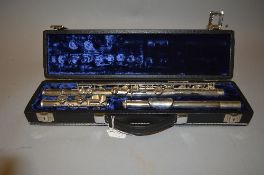 A CASED YAMAHA YFL 21N FLUTE, silver coloured with a stamped Serial Number at the base of the centre