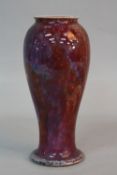 A RUSKIN POTTERY BALUSTER VASE, with flared foot, blue speckled red flambe glaze, impressed Ruskin