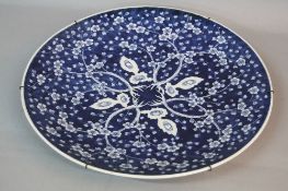 A LATE 19TH CENTURY JAPANESE BLUE AND WHITE PORCELAIN CHARGER, decorated with prunus blossom