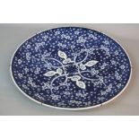 A LATE 19TH CENTURY JAPANESE BLUE AND WHITE PORCELAIN CHARGER, decorated with prunus blossom