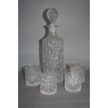 A WHITEFRIARS GLACIER RANGE CYLINDRICAL DECANTER WITH STOPPER, together with a set of four