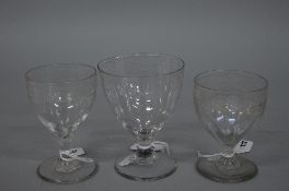 THREE LATE 18TH CENTURY FUNNEL BOWLED DRINKING GLASSES, on short stems, all three with engraved