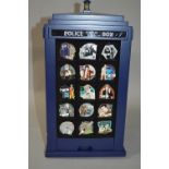 A DANBURY MINT REVOLVING DOCTOR WHO TARDIS PIN BADGE HOLDER, complete with all badges, appears