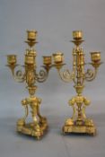 A PAIR OF MID 19TH CENTURY ORMOLU FOUR BRANCH CANDELABRA GARNITURES, beaded rims to sconces and drip