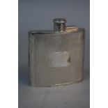 AN ELIZABETH II SILVER HIP FLASK, of concave form, engine turned decoration with vacant