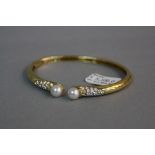 A MODERN 18CT GOLD PICCHIOTTI DIAMOND AND CULTURED PEARL TORQUE DESIGN BANGLE, an oval bangle with