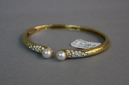 A MODERN 18CT GOLD PICCHIOTTI DIAMOND AND CULTURED PEARL TORQUE DESIGN BANGLE, an oval bangle with