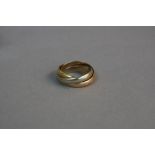 A CARTIER TRINITY RING, marked 750, engraved Le Must de Cartier, size J 1/2, original Cartier box,