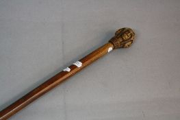 A LATE 19TH CENTURY KEPKYPA (CORFU) WALKING STICK, the wooden pommel carved as four male