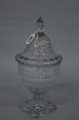 A LATE GEORGIAN CUT GLASS URN SHAPED PEDESTAL BOWL AND COVER, the domed cover with facet cut