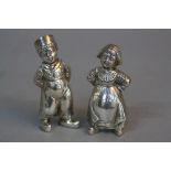 A NEAR PAIR OF 20TH CENTURY CONTINENTAL SILVER PEPPERETTES, in the form of a Dutch Boy and Girl,