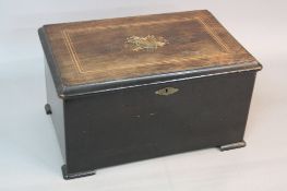 A LATE 19TH CENTURY ROSEWOOD AND EBONISED SWISS MUSIC BOX, the hinged lid with inlay and central