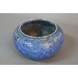 A RUSKIN POTTERY BOWL, of squat baluster form, mottled matt blue glaze, impressed marks Ruskin