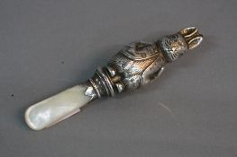 A GEORGE VI SILVER AND MOTHER OF PEARL BABY'S RATTLE, in the form of Peter Rabbit, makers mark for