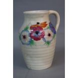 A CLARICE CLIFF ISIS JUG, mushroom ground painted with 'Anemone' flowers, drilled hole towards