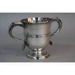 A GEORGE II SILVER LOVING CUP, twin 'S' scroll handles, circular body with single band, circular