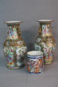 A PAIR OF 19TH CENTURY CHINESE PORCELAIN FAMILLE ROSE BALUSTER VASES, frilled rims, the bodies