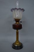 A LATE VICTORIAN OIL LAMP, the opaque glass shade with crackle moulding and wavy amethyst rim,