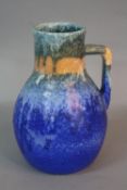 A RUSKIN POTTERY EWER, of baluster form, streaked and banded matt glazes in turquoise, orange and