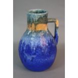 A RUSKIN POTTERY EWER, of baluster form, streaked and banded matt glazes in turquoise, orange and