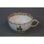 A 19TH CENTURY MEISSEN TEA CUP, of wavy outline, gilt border to the interior with flower spray,