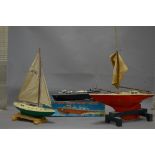 AN UNBOXED TRI-ANG OSPREY POND YACHT, with an unboxed Penguin plastic racing pond yacht (16''