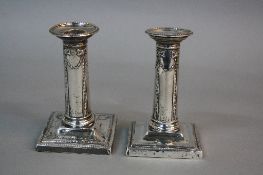 A PAIR OF LATE VICTORIAN GOLDSMITHS & SILVERSMITHS CO DWARF CANDLESTICKS, beaded rims, ribbon,