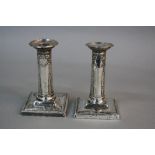 A PAIR OF LATE VICTORIAN GOLDSMITHS & SILVERSMITHS CO DWARF CANDLESTICKS, beaded rims, ribbon,