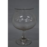 A MID 19TH CENTURY GLASS LEECH JAR, with turned over plain rim, globular bowl, plain stem and deep