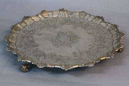 A GEORGE II SILVER SALVER, shell and scroll border, later chased and embossed with floral foliate