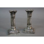 A PAIR OF VICTORIAN SILVER CANDLESTICKS, detachable shaped square sconces, Corinthian capped