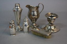 AN EDWARDIAN SILVER CREAM JUG, strap work 'S' scroll handle, on a short pedestal with stepped