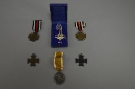 A SMALL COLLECTION OF GERMAN WWII MEDALS, consisting of a Mothers Cross, in original box in