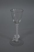 AN 18TH CENTURY CORDIAL GLASS, with rounded funnel shaped bowl and enamel double air twist stem,